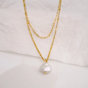 Double-layered gold titanium steel necklace featuring baroque pearl and star charm