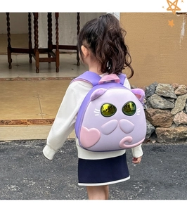 Toddler backpack with purple cat shell design worn by a child outdoors