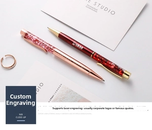 Detailed macro view of custom rose gold and burgundy glitter pens with laser engraving