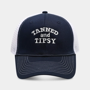 Detailed embroidery of TANNED and TIPSY on navy cotton front and white mesh trucker hat