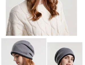 Detail of grey cable-knit slouchy beanie with black trim and cream textured sweater