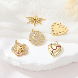 Exquisite gold plated star and heart jewelry pendants with sparkling zircon on marble
