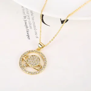 Saturn pendant necklace in 18K gold plated copper with shimmering zircon crystals