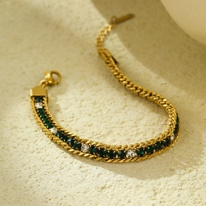 Detailed macro of gold bracelet with alternating green and clear zircon crystals