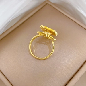Detail of gold rotating evil eye ring with radiant gear layers in a jewelry box