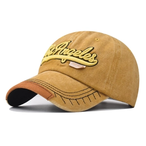 Detailed embroidery of Los Angeles on washed cotton baseball cap with leather visor brim