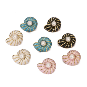 Colorful shell-shaped enamel earrings with gold trim and pearls on a white background