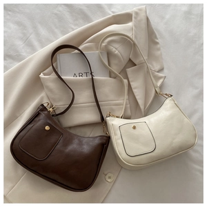 Detailed close-up of retro square shoulder bags in brown and beige PU leather with gold snaps