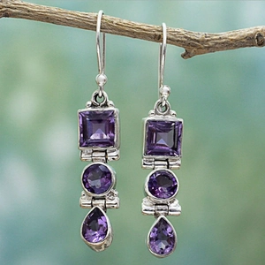 Macro shot of vintage amethyst silver earrings with geometric square and teardrop gems