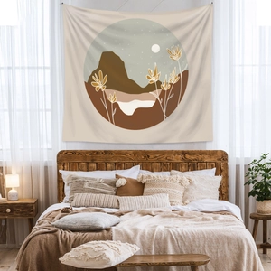 Bohemian wall tapestry showing abstract mountains and moon in a cozy bedroom setup