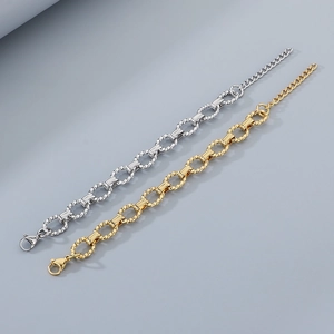 Detail of twisted oval chain bracelets in gold and silver finish with lobster clasp