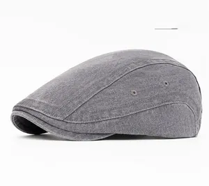 Detail of grey washed canvas beret with metal air vents and precise stitching texture