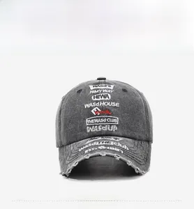 Close-up of vintage washed grey baseball cap with distressed holes and embroidery