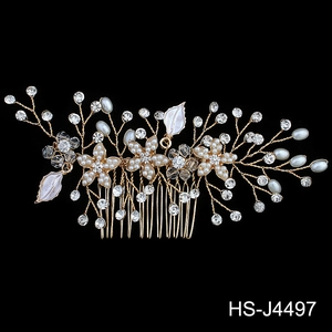 Detail of bridal hair comb with gold wires, white pearls, and sparkling crystals
