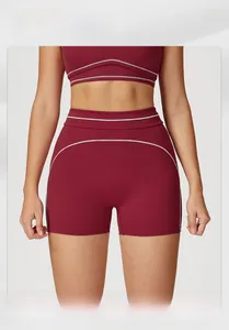 Detail of burgundy yoga set featuring white contrast stitching and high elasticity