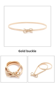Close-up of golden bow-knot buckle on elastic metal waist belt for women dresses