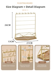 Detail view of gold iron jewelry display with wooden base showing hooks and dimensions