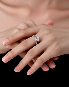 Detailed view of S925 sterling silver ring with flower-shaped moissanite on model hand
