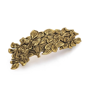 Vintage bronze flower hair clip with detailed floral carvings and spring closure