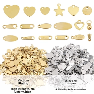 Close-up of stainless steel heart and star tags for jewelry making in gold and silver