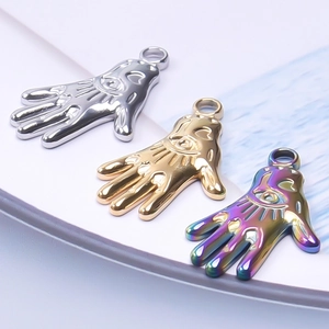 Polished Hamsa Hand pendants in gold, silver, and rainbow steel with heart cutouts
