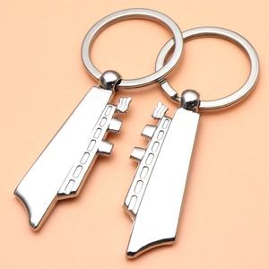 Polished silver cruise ship couple keychain set featuring two halves of a creative boat design