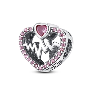 Detailed macro of heart charm with pink zircon and pulse wave silver plated metal