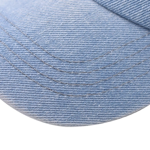 Macro detail of the light blue denim brim with reinforced stitching on this baseball cap
