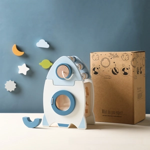 Detail view of wooden rocket activity toy with elegant gift box and star patterns