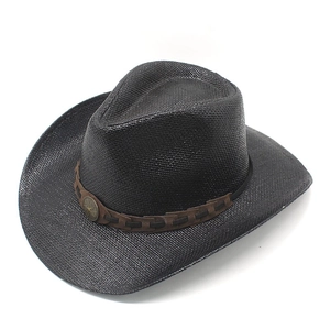 Close-up of black straw cowboy hat with a star-studded leather band detail