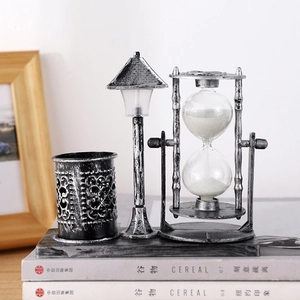 Vintage industrial desk organizer with lighthouse lamp, rotating hourglass, and pen holder