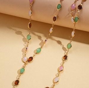 Elegant gold chain necklace with colorful oval resin stones in green, pink and amber