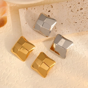 Minimalist irregular 18k gold and silver square stud earrings on stone tray