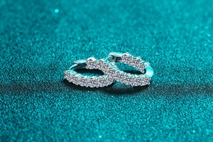 Macro shot of silver S925 sterling silver hoop earrings with sparkling pavé moissanite