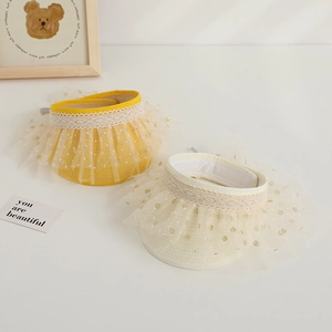 Detailed lace trim and gold polka dot tulle on children sun visor hats in yellow and cream