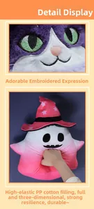Detail of plush cat toy showing purple face embroidery and soft pink wizard hat texture