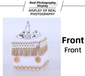 Detail of white foam gift box ornament with lace, burlap fringe and wood button accents