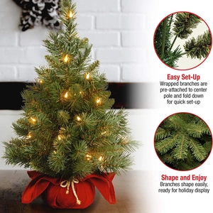 Mini desktop Christmas tree with lights and red fabric base for holiday decoration