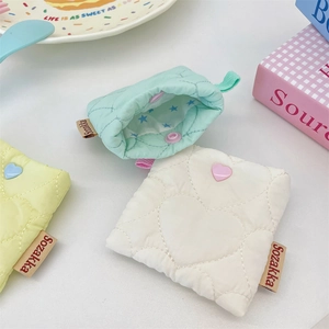 Detailed view of heart-quilted soft earphone cases in pastel colors with star lining