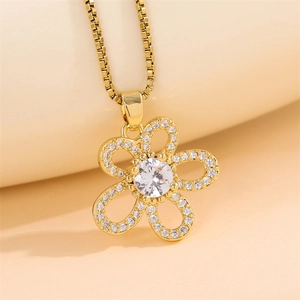 Elegant gold flower pendant necklace with clear zircon crystals on warm beige background