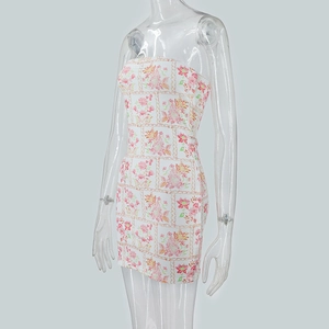 Detail of white strapless bodycon dress with pink floral and gold chain pattern
