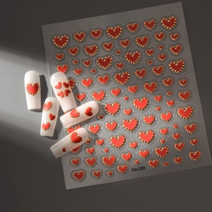 3D embossed red heart nail stickers with gold edges on minimalist dark background
