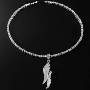 Macro detail of silver hip hop wing pendant necklace with sparkling micro diamonds