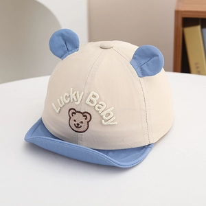 Close-up of the Lucky Baby embroidery and cute bear ears on this baby sun hat