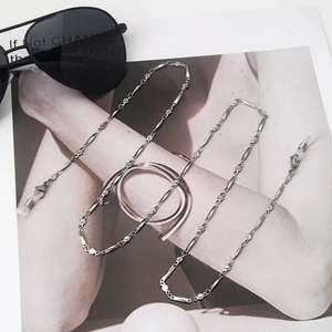 Detail of silver stainless steel eyewear chain with sunburst discs and silicone loops