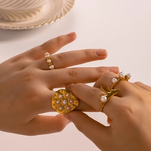 Irregular 18K gold plated stainless steel ring set with elegant white pearls on model hand