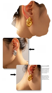 Close-up of geometric heart-shaped double-layer gold and silver titanium earrings on a model