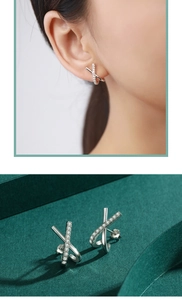 Macro detail of S925 sterling silver X-shaped cross earrings with cubic zirconia stones