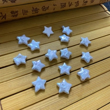 Detailed macro view of star-shaped natural freshwater pearls with iridescent luster on bamboo