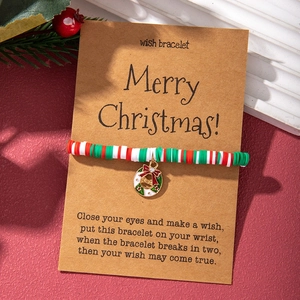 Detailed view of Christmas wish bracelet with colorful clay beads and festive wreath charm